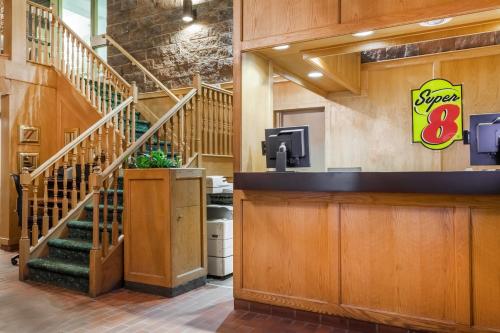 a lobby of a star restaurant with stairs at Super 8 by Wyndham Sudbury ON in Sudbury