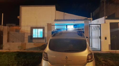 a car parked in front of a house at night at La Goldie in Concepción del Uruguay