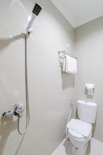 a bathroom with a shower and a toilet at HOME 88 Feels Like Home in Sleman