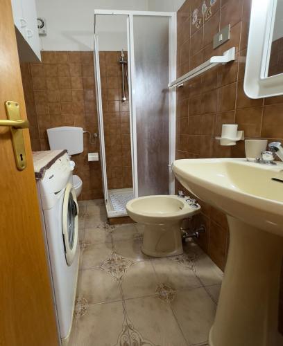 a bathroom with a toilet and a sink and a shower at Tre Archi Sea Home in Lido di Fermo