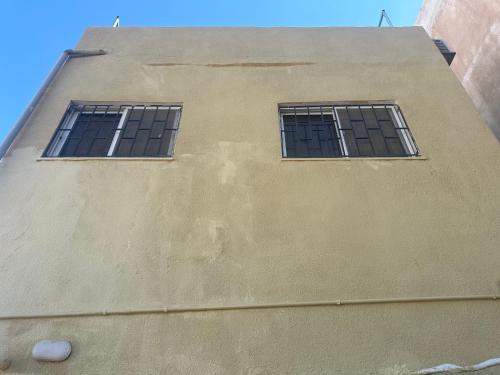 two windows on the side of a building at Jalal House in Amman