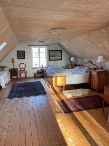 a bedroom with a bed and a wooden ceiling at Fårhuset at Åkarp in Trelleborg