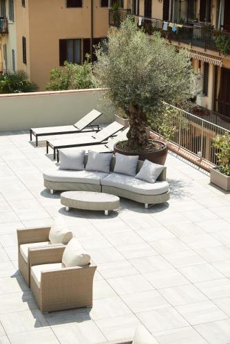 a group of couches and a tree on a patio at Forte16 View & SPA in Florence