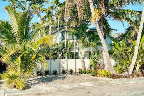 a building with palm trees in front of it at Art Deco Apt w Pool One Mile to Beach Pets Welcome in Lake Worth