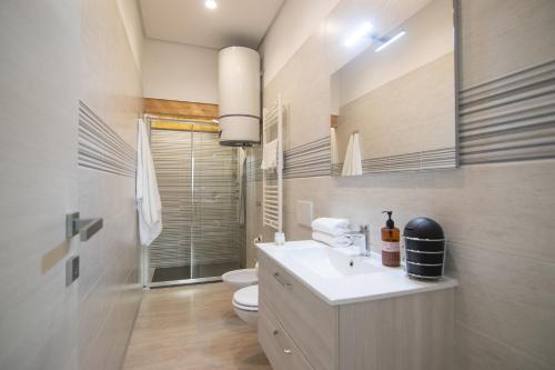 a bathroom with a white sink and a toilet at B&B Cannito in Altamura