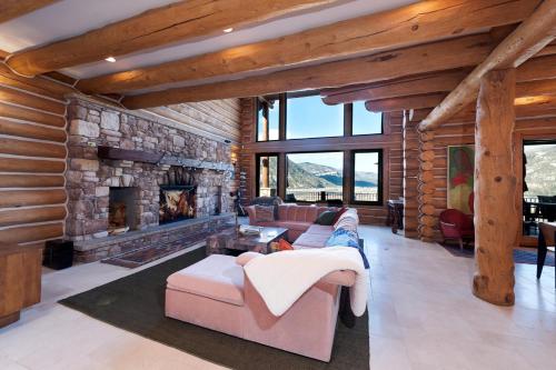 a large living room with a stone fireplace at 526 Alan Rd - Durango CO. in Durango