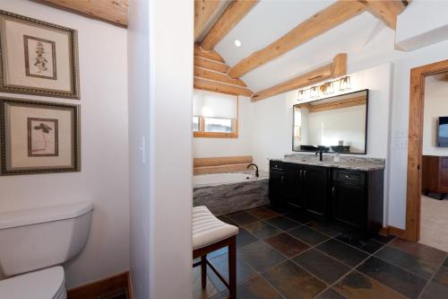 a bathroom with a toilet and a sink and a tub at 526 Alan Rd - Durango CO. in Durango