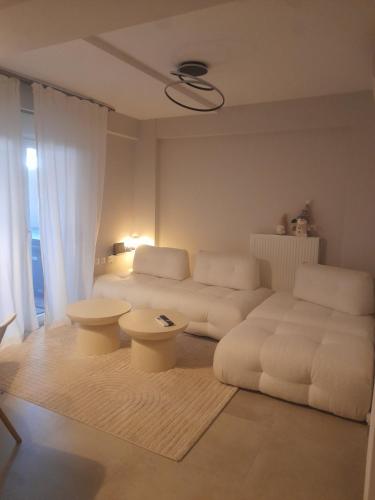a living room with a couch and a table at Nature Nest in Larisa
