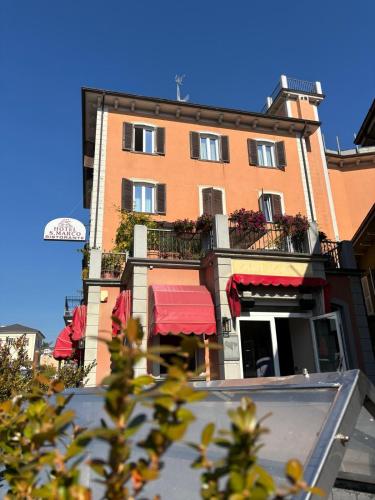 a tall building with a balcony with flowers on it at Hotel San Marco in Bedonia