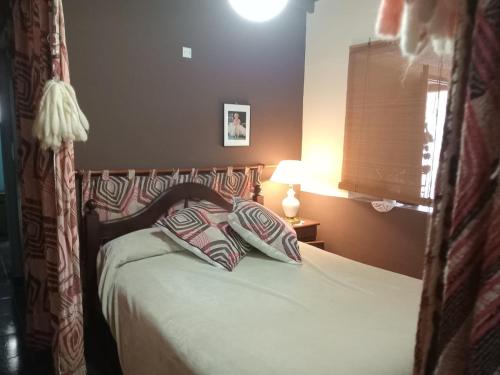 a bedroom with a bed with two pillows on it at Nahomi House in Barrio Félix U Camet