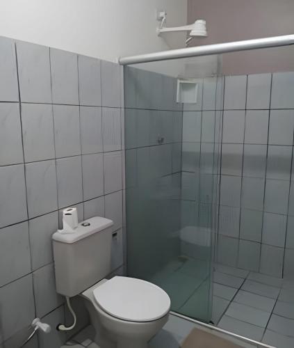a bathroom with a toilet and a glass shower at Casa em Maceió Para Alojamento ou Família Grande in Maceió