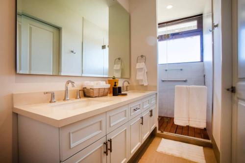 a bathroom with a sink and a mirror and a shower at Elegance - Jungle meet with private pool heated in Bucerías