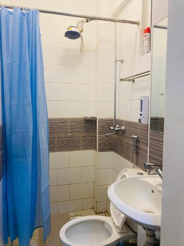 a bathroom with a toilet and a sink at Residence Next Door Gz in Kiambu