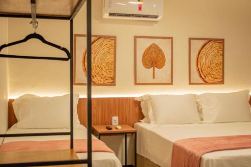 a hotel room with two beds and a bunk bed at Viamar Home in Natal