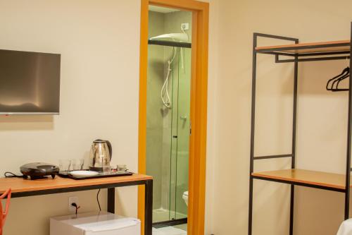 a bathroom with a shower and a toilet in a room at Viamar Home in Natal
