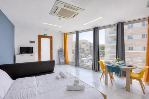 a living room with a couch and a table at Kalimera Studios in Hamrun