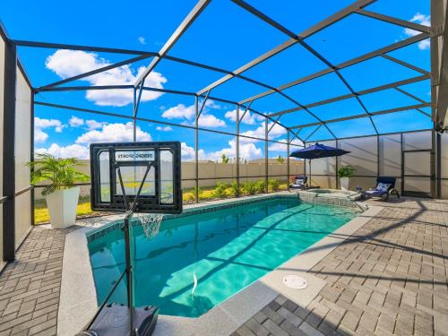 a swimming pool with a pergola and an indoor swimming pool at New 10-bedroom Luxury Retreat, Private Pool and Spa, Near Disney and Orlando in Clermont