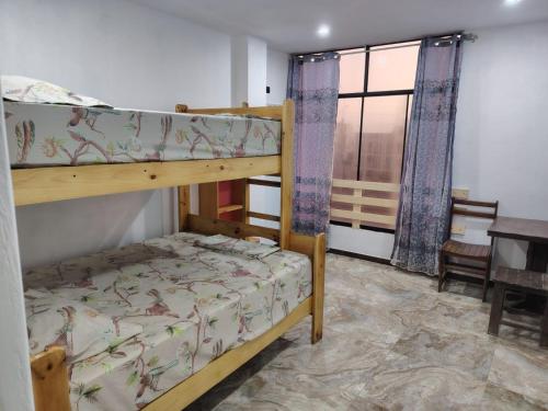 a bedroom with two bunk beds and a table at Ocean Glips II in Punta Negra