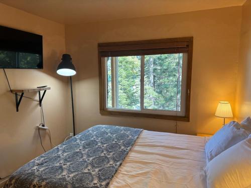 a bedroom with a large bed and a window at Mountain Cabin at Heavenly in Stateline