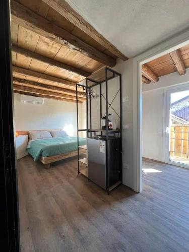 a bedroom with a bed and a glass room at GIAMI affittacamere & SPA in Santa Giustina