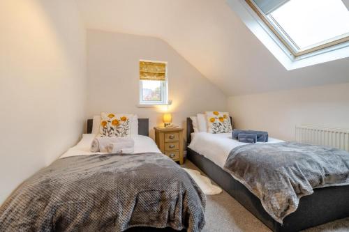 two beds in a attic bedroom with a skylight at 3 Bed in Brithdir oc-c33971 in Llanfachreth