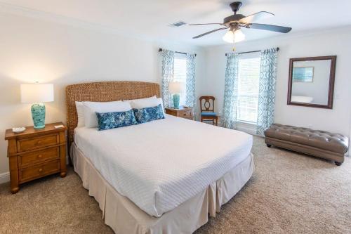 a bedroom with a bed and a ceiling fan at Hello Sunshine in Santa Rosa Beach