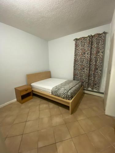 a small bedroom with a bed and a window at private room in Paterson