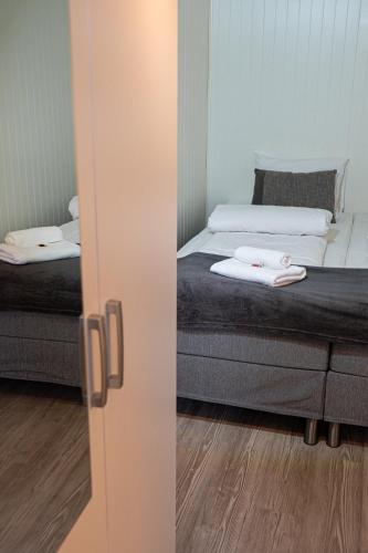 a room with two beds and a mirror at Modern apartment near train station H77A in Narvik