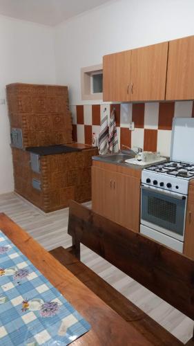 una cucina con mobili in legno e una stufa di CASA CU LAVANDĂ a Vatra Dornei