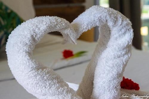 a towel shaped like a heart sitting on a table at La Belle Rodriguaise in Rodrigues Island