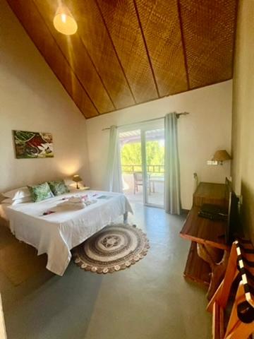 a bedroom with a bed and a large window at La Belle Rodriguaise in Rodrigues Island