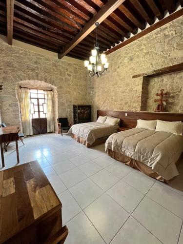a large room with two beds and a table at Casa Alzate in Morelia