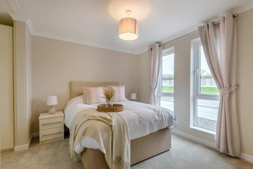 a white bedroom with a bed and a window at 2 Bed in Evesham oc-f33689 in Admington