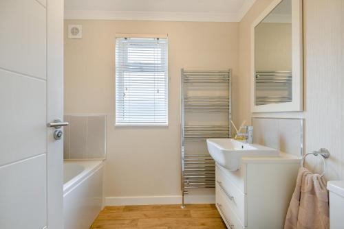 a white bathroom with a sink and a mirror at 2 Bed in Evesham oc-f33689 in Admington