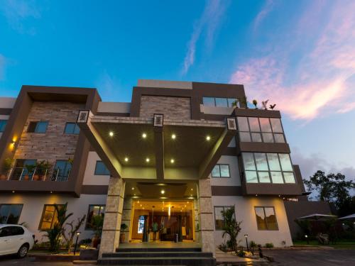 a building with people sitting on top of it at The Palms by Eagles in Takoradi