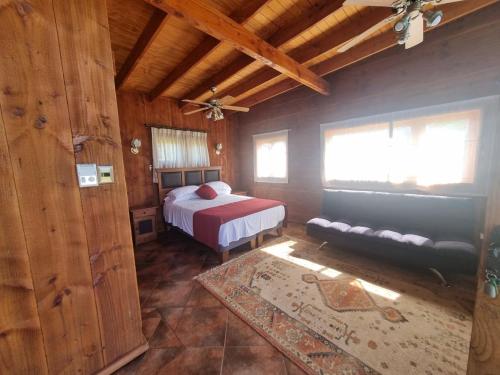 a bedroom with a bed and a couch in a room at Texas Limache in Limache