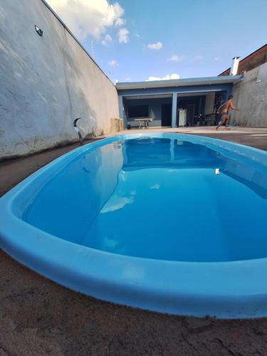 a large blue swimming pool sitting next to a building at Diony in Brotas