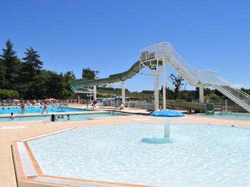 a water slide in a swimming pool with people in it at Chalet 35m² avec Terrasse, 2 Chambres - API-1-52-1014 in Boulogne-sur-Gesse