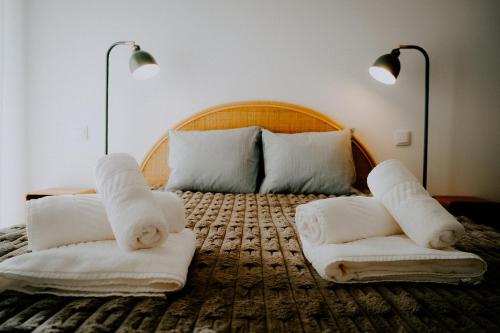 a bedroom with a bed with towels on it at Slow Living Apúlia in Apúlia