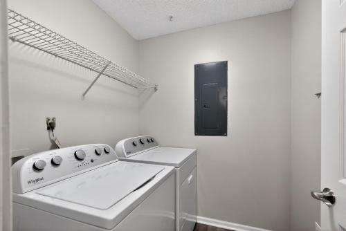a white laundry room with a washer and dryer at Bright Stockbridge condo with full kitchen in Stockbridge