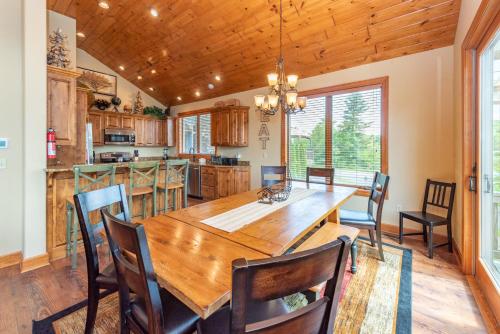 a kitchen and dining room with a wooden table and chairs at Firefly Cove by Railey Vacations in McHenry