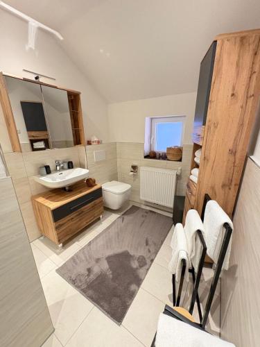 a bathroom with a sink and a toilet at Am Storchennest in Walsrode