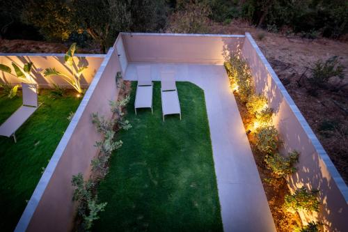 an overhead view of a garden with two benches at Mystrali 1BD Modern Apt with Private Garden in Galatás