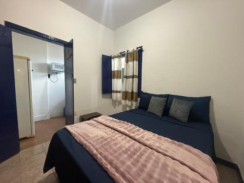 a bedroom with a bed with a blanket on it at Refúgio Colonial 3 - Antonio Dias in Ouro Preto