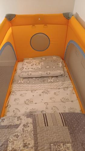 an orange bed with a mattress in a room at Casa Maricciotti in Terni