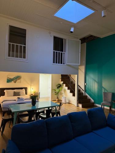 a living room with a blue couch and a table at The Lofts at 107 in Nashville