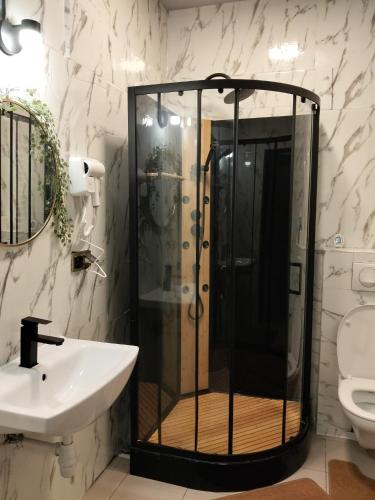 a bathroom with a shower and a sink at Villa Varzob lll in Warsaw