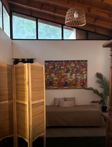 a bedroom with a bed and a painting on the wall at Quinta con pileta in Brandsen