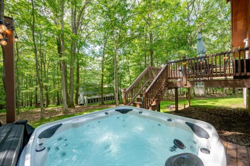 a hot tub in a yard with a deck at Get Your Creek On by Railey Vacations in Swanton