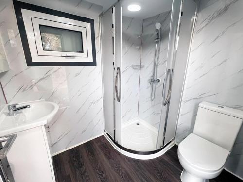 a bathroom with a shower and a toilet and a sink at Ukiyo Nature Retreat in Fingal